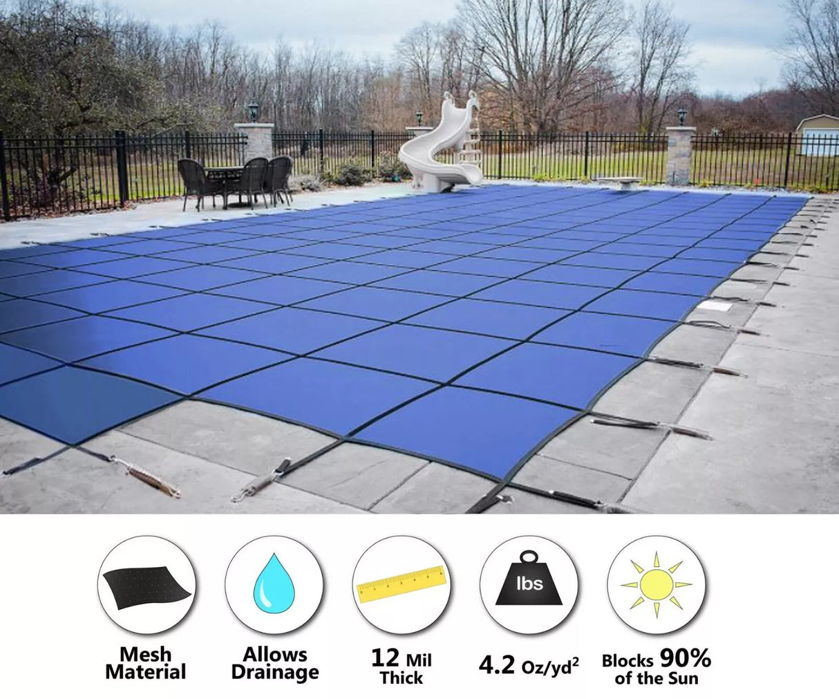 Blue mesh winter pool cover installed over a rectangular in-ground pool with center steps and anchor straps.