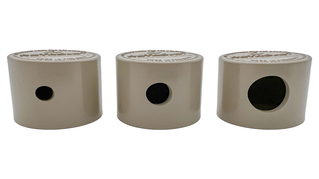 Three beige QuickClean nozzle inserts in different sizes with side openings