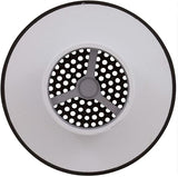 Round white and black suction outlet cover with perforated center and three-spoke grille