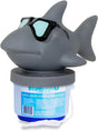 Gray shark-shaped floating pool chlorine dispenser with sunglasses on a clear blue base
