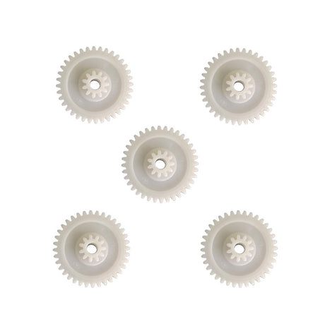 Five white plastic gear reduction wheels on a white background